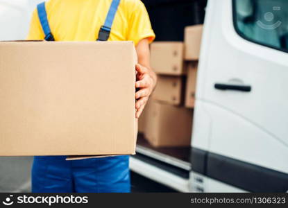 Young male barista makes latte, cafe counter and espresso machine on background. Barman works in cafeteria, bartender prepares coffee. Young male barista makes latte