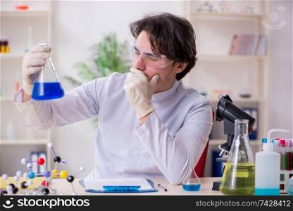 Young male biochemist working in the lab 