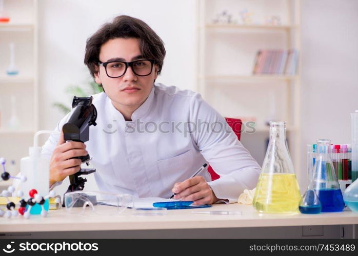 Young male biochemist working in the lab 