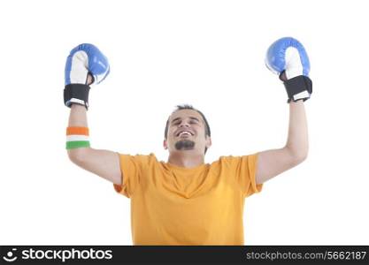 Young male boxer with eyes closed standing hands raised over white background