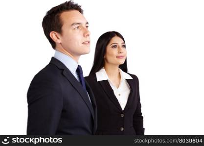 Young male business man and female business woman standing together smiling. A young business man and business woman standing together looking at a distance. They are smiling.