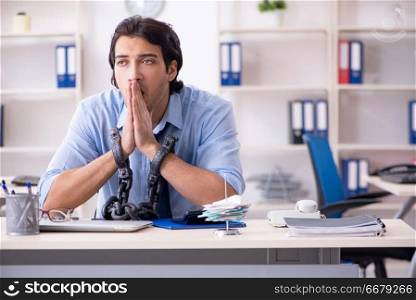 Young male businessman employee unhappy with excessive work  
