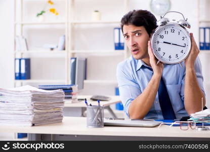 Young male businessman employee unhappy with excessive work  