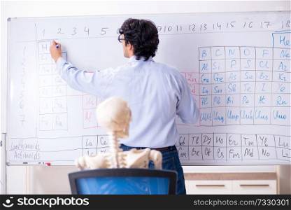 Young male chemist teacher and student skeleton 