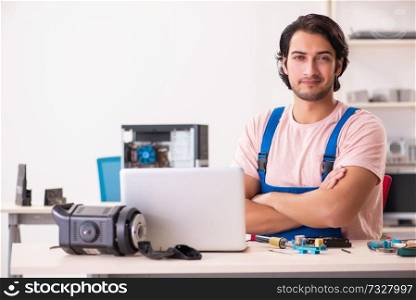Young male contractor repairing computer  