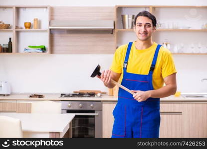 Young male contractor repairing tap at home 