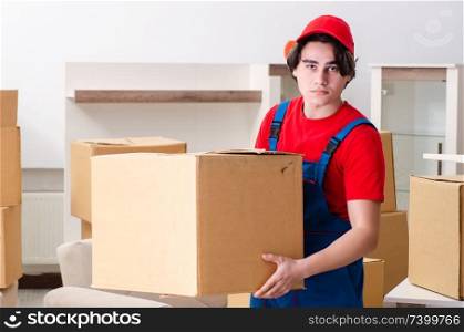 Young male contractor with boxes working indoors 