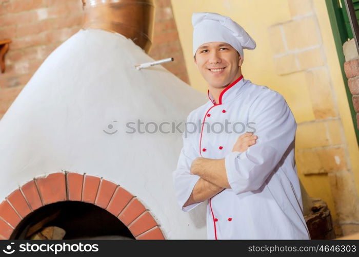 Young male cook. Image of young handsome male cook at kitchen