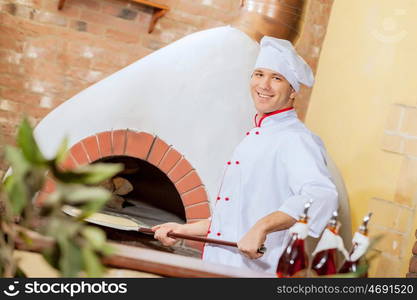 Young male cook. Image of young handsome male cook at kitchen