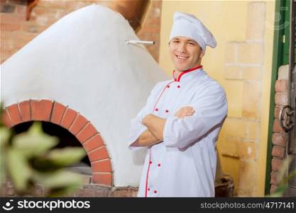 Young male cook. Image of young handsome male cook at kitchen