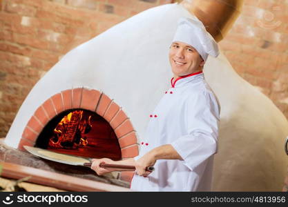 Young male cook. Image of young handsome male cook at kitchen