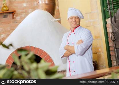 Young male cook. Image of young handsome male cook at kitchen
