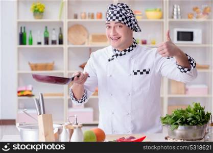 Young male cook working in the kitchen