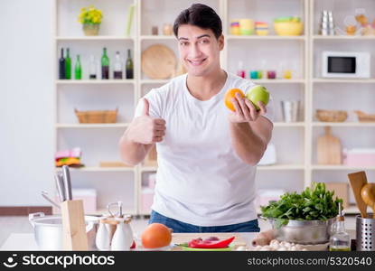 Young male cook working in the kitchen