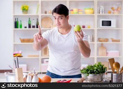 Young male cook working in the kitchen