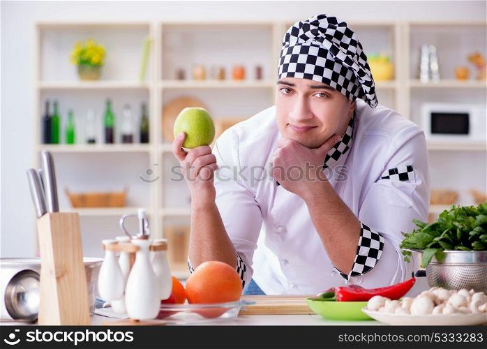 Young male cook working in the kitchen