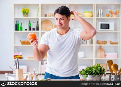 Young male cook working in the kitchen