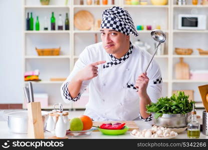 Young male cook working in the kitchen