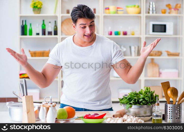 Young male cook working in the kitchen