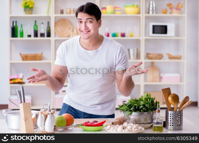 Young male cook working in the kitchen