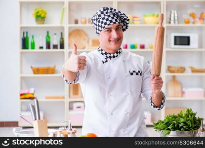 Young male cook working in the kitchen