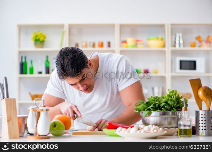 Young male cook working in the kitchen