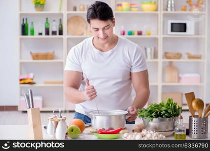 Young male cook working in the kitchen