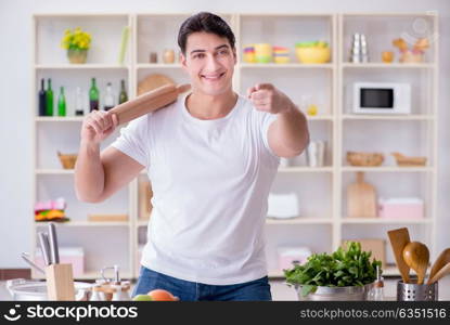 Young male cook working in the kitchen