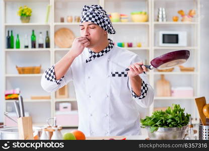 Young male cook working in the kitchen