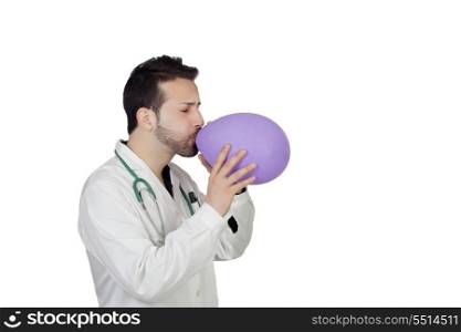 Young Male Doctor Blowing Balloon Over White Background
