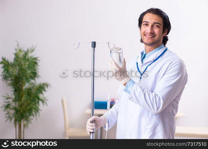 Young male doctor in blood transfusion concept 