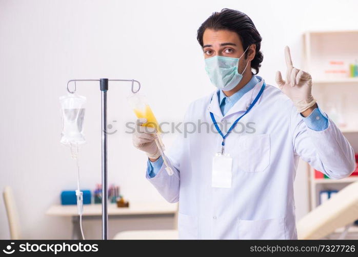 Young male doctor in blood transfusion concept 