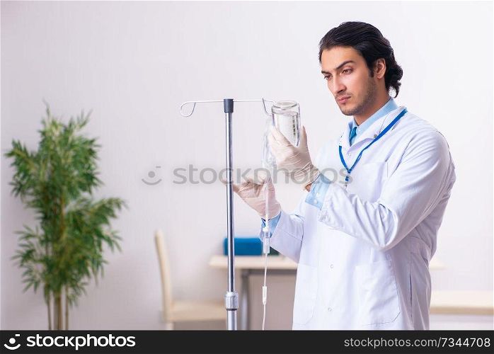 Young male doctor in blood transfusion concept 