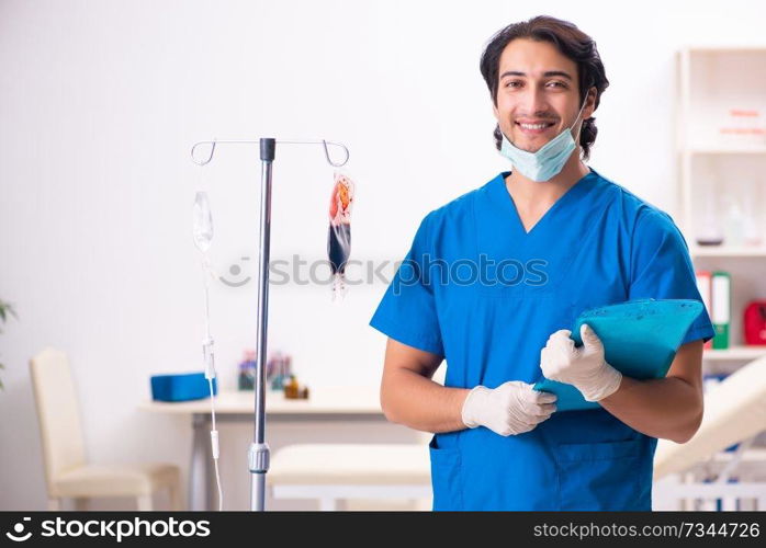 Young male doctor in blood transfusion concept 