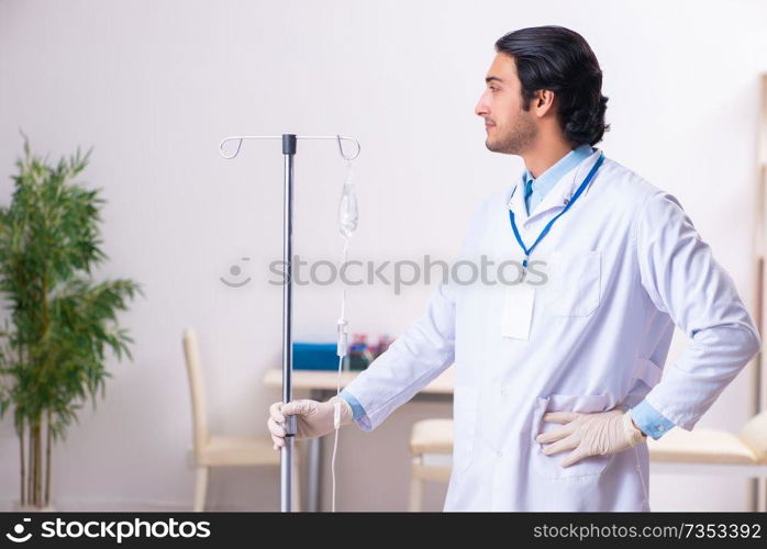 Young male doctor in blood transfusion concept 