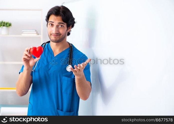 Young male doctor in front of whiteboard 