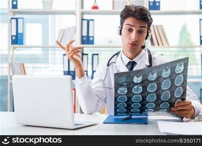 Young male doctor in telehealth concept