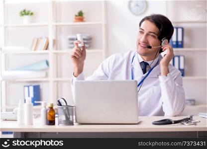 Young male doctor in telemedicine concept 