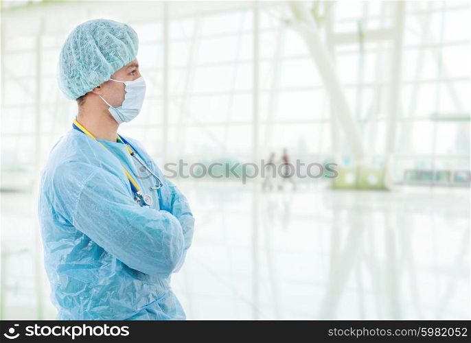 young male doctor looking at the right at the hospital