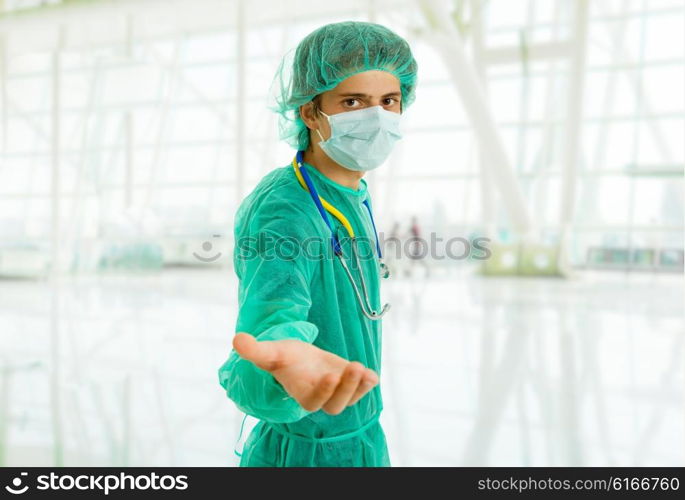 young male doctor offering hand, focus on the face