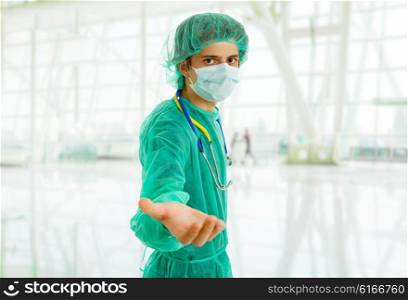 young male doctor offering hand, focus on the face