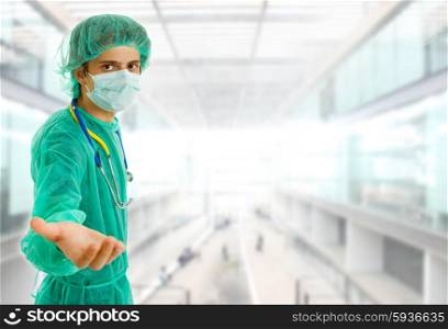 young male doctor offering his hand at the hospital