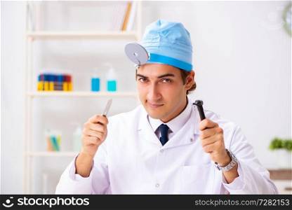 Young male doctor otolaryngologist working at the hospital 