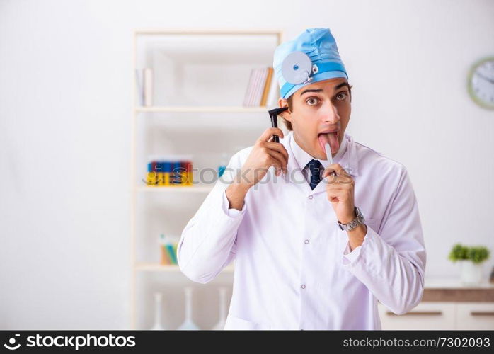 Young male doctor otolaryngologist working at the hospital 