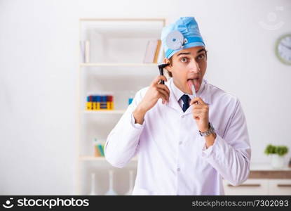 Young male doctor otolaryngologist working at the hospital 