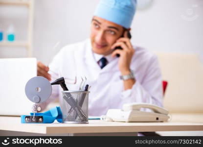 Young male doctor otolaryngologist working at the hospital 