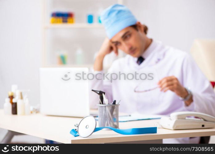 Young male doctor otolaryngologist working at the hospital 