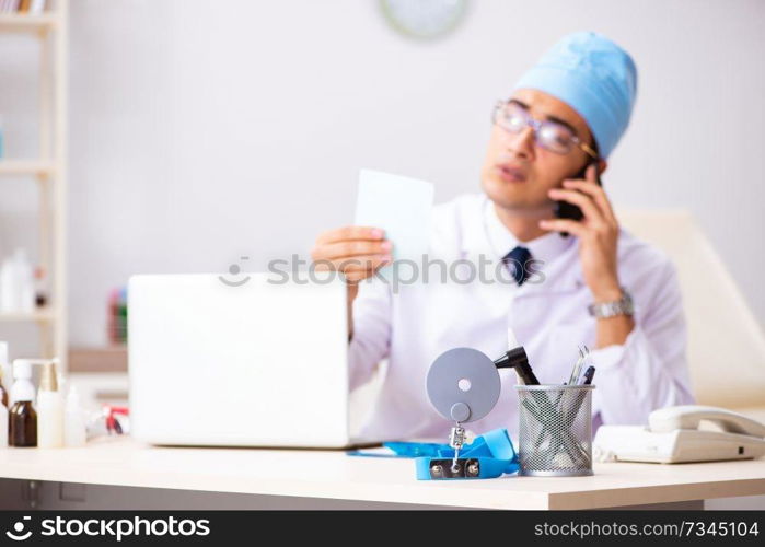 Young male doctor otolaryngologist working at the hospital 