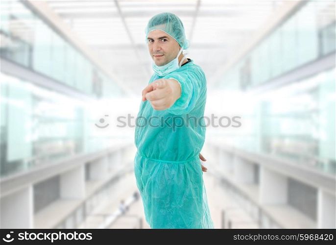 young male doctor pointing at the hospital