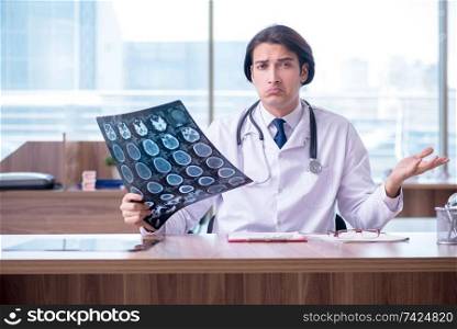 Young male doctor radiologist working in the clinic 